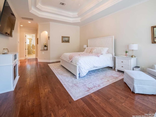 bedroom featuring a raised ceiling, crown molding, and dark hardwood / wood-style flooring