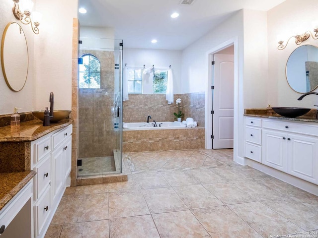 bathroom featuring tile patterned flooring, vanity, and separate shower and tub