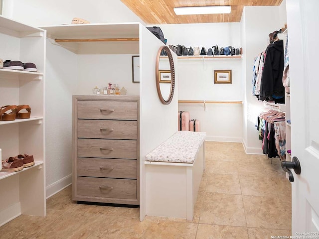 walk in closet with light tile patterned floors