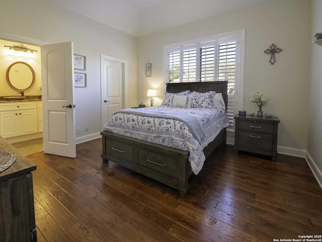 bedroom featuring ensuite bathroom and dark hardwood / wood-style floors