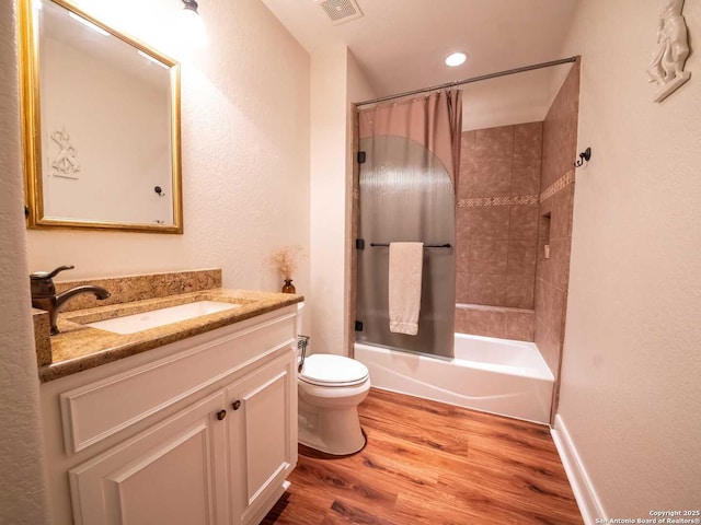 full bathroom with shower / tub combo, vanity, toilet, and hardwood / wood-style floors