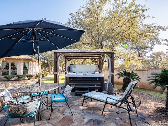 view of patio with a grill and a hot tub