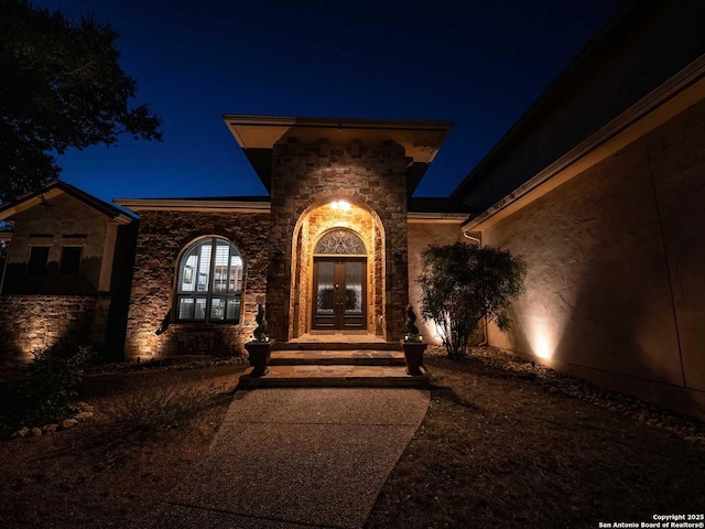 exterior entry at night featuring french doors