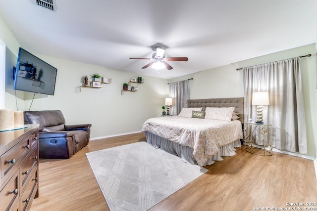 bedroom with ceiling fan and light hardwood / wood-style floors