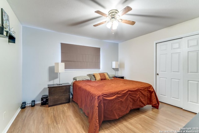 bedroom featuring a closet, ceiling fan, and light wood-type flooring