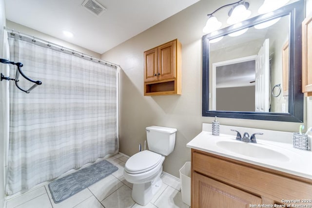 bathroom featuring vanity, tile patterned flooring, and toilet