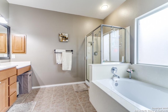 bathroom with vanity, tile patterned flooring, and plus walk in shower