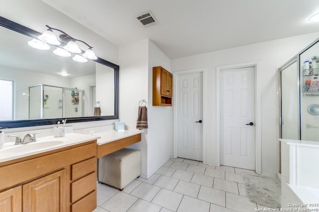 bathroom with vanity, tile patterned floors, and a shower with shower door