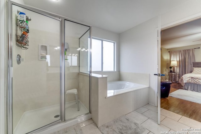 bathroom featuring shower with separate bathtub and tile patterned floors