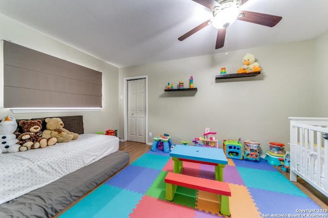 bedroom with wood-type flooring, ceiling fan, and a closet