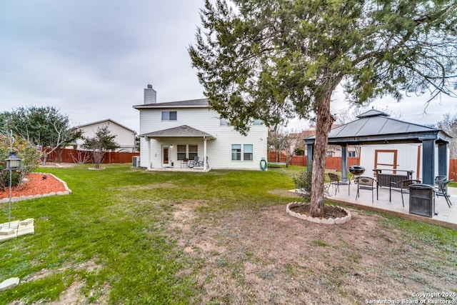 back of house with a gazebo, a lawn, and a patio