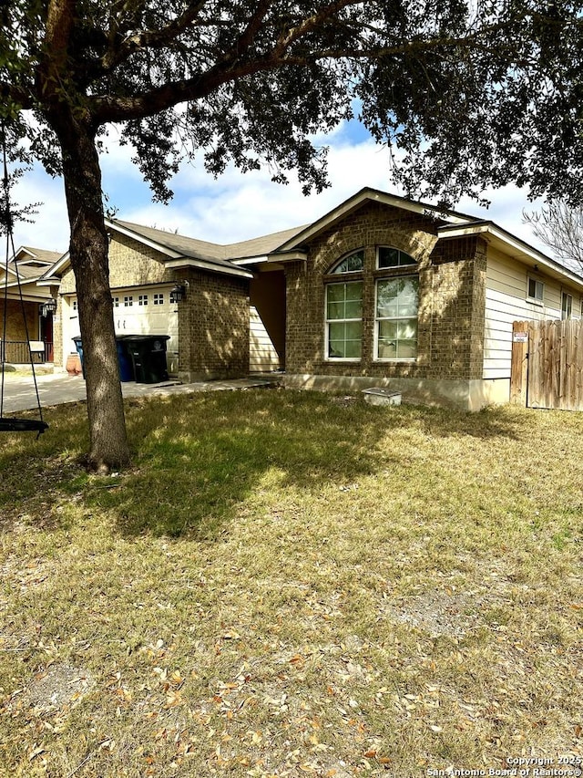 view of front of house with a garage and a front lawn