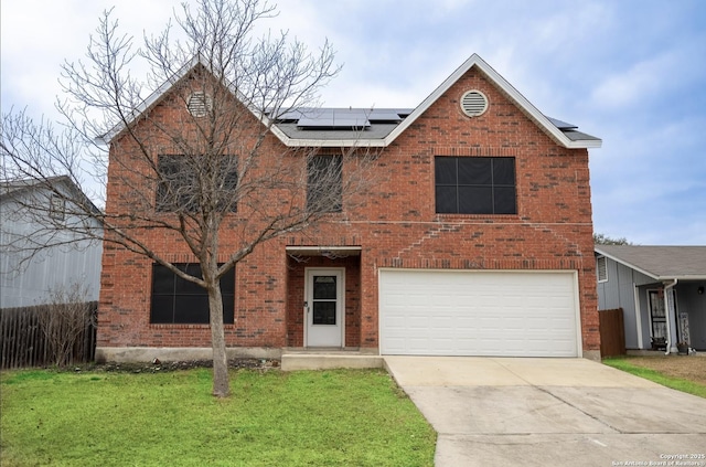 view of front of property featuring a garage, a front lawn, and solar panels