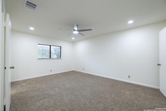 carpeted spare room with ceiling fan