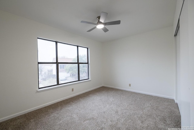 carpeted empty room with ceiling fan