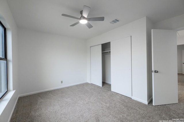 unfurnished bedroom with ceiling fan, carpet flooring, and a closet