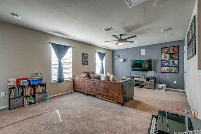 carpeted living room with ceiling fan and a textured ceiling