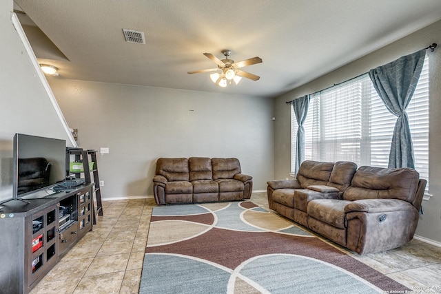 tiled living room with ceiling fan