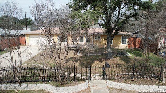 ranch-style home with fence, driveway, and an attached garage