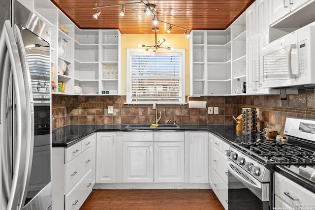 kitchen with open shelves, stainless steel appliances, dark countertops, wood ceiling, and a sink