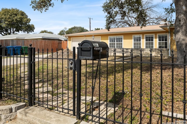 view of gate with a fenced front yard