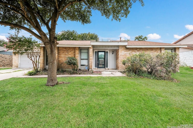 ranch-style home with a garage and a front lawn