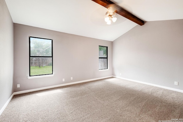 unfurnished room with ceiling fan, carpet flooring, and vaulted ceiling with beams