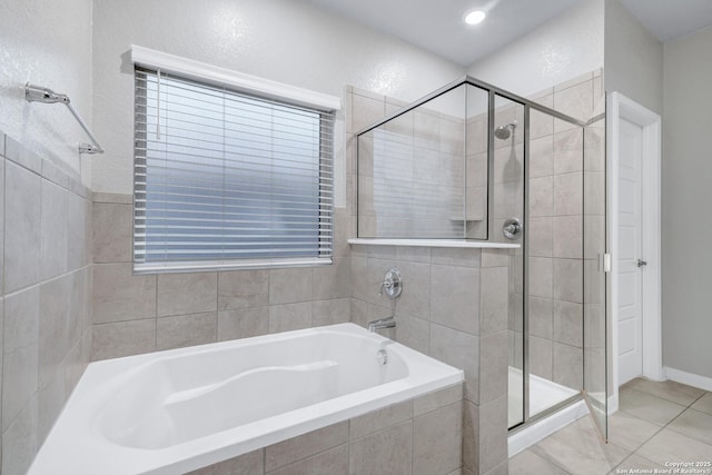 bathroom with separate shower and tub and tile patterned floors