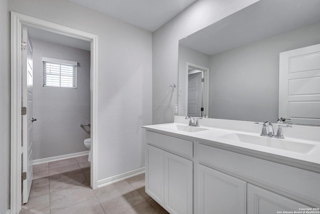 bathroom featuring vanity, tile patterned floors, and toilet