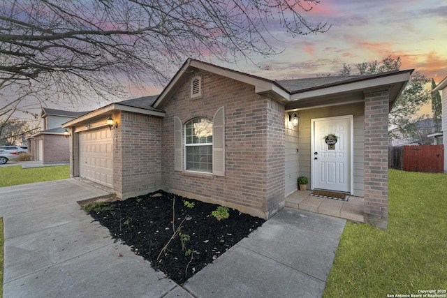 view of front facade with a garage and a lawn