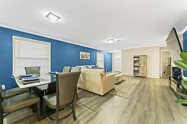 living room with ornamental molding and wood-type flooring