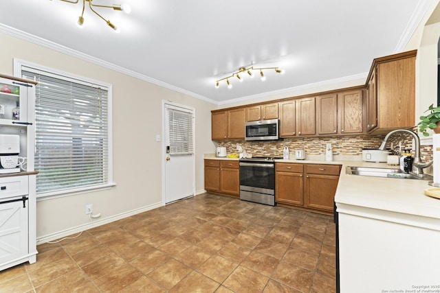 kitchen with stainless steel appliances, crown molding, sink, and backsplash