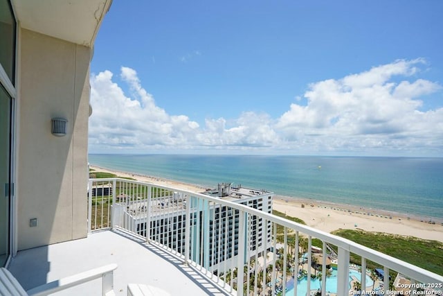 balcony featuring a water view and a beach view