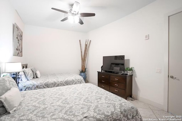 tiled bedroom with ceiling fan