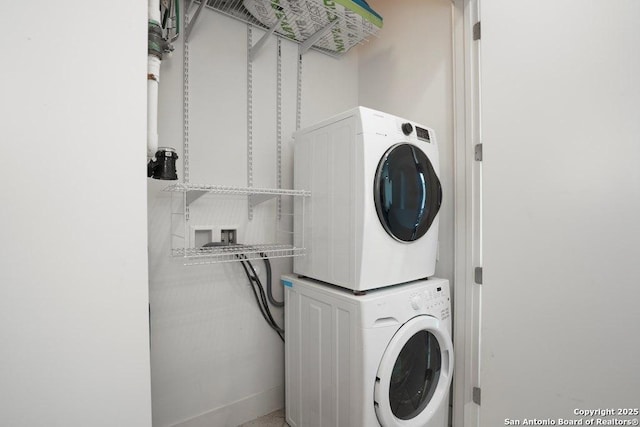 laundry area with stacked washer / dryer