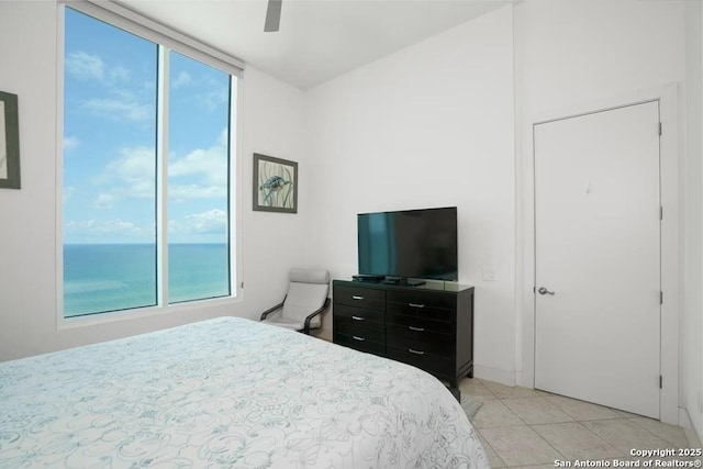 tiled bedroom featuring ceiling fan