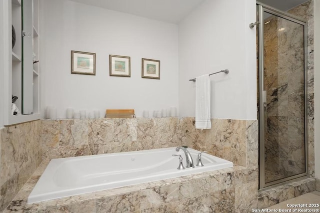 bathroom featuring shower with separate bathtub