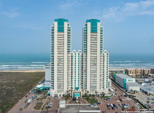 view of property featuring a water view and a view of the beach