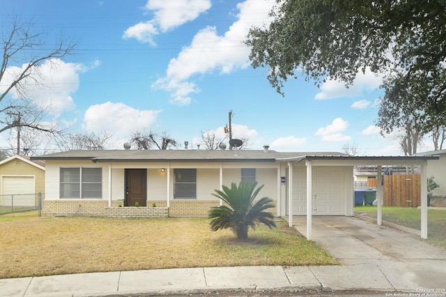 ranch-style home with a carport, a garage, and a front yard