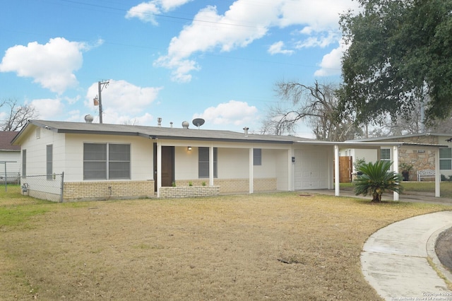 ranch-style house with a carport and a front lawn