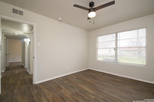 empty room featuring ceiling fan and dark hardwood / wood-style flooring