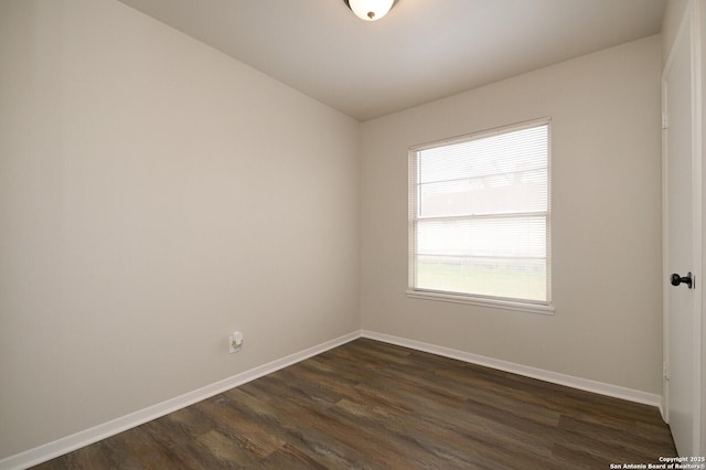 spare room featuring dark wood-type flooring