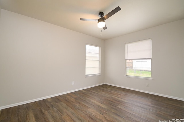 spare room featuring ceiling fan and dark hardwood / wood-style flooring