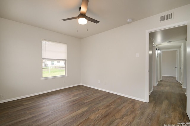 empty room with dark wood-type flooring and ceiling fan