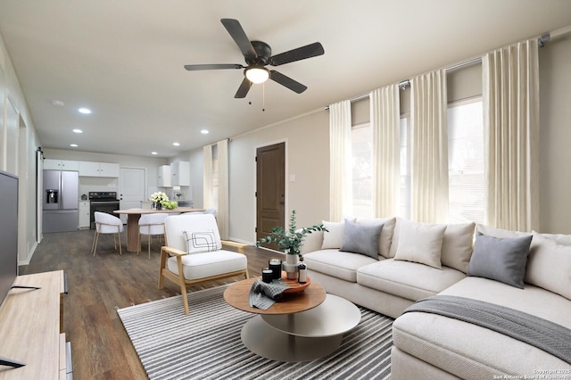 living room with dark hardwood / wood-style floors and ceiling fan