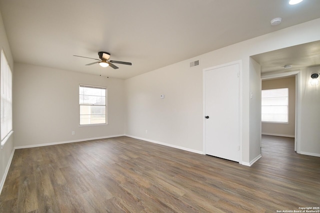 empty room featuring ceiling fan and dark hardwood / wood-style floors