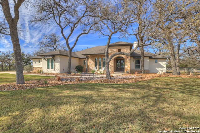 view of front of house with a front lawn and french doors