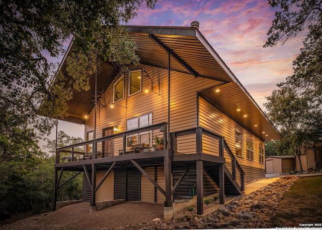 exterior space featuring a shed and a wooden deck