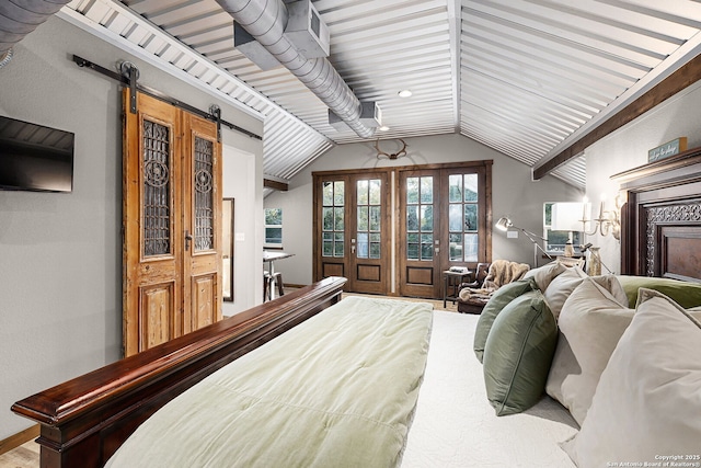 bedroom with a barn door, access to outside, and lofted ceiling