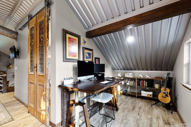 office area featuring light wood-type flooring and vaulted ceiling with beams